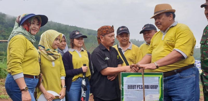 Direktur Utama PT Sarbi Grup Ir. H. Ateng Sutisna, MBA (paling kanan) menyerahkan secara simbolis bibit pohon dan tanaman buah-buahan kepada wakil masyarakat Desa Giri Senang, Kecamatan Cilengkrang, kawasan Bandung Utara. Foto: Istimewa