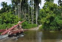 Petugas PLN membawa material pendukung kelistrikan menembus sungai ke Desa Gunung Menasaha, Kecamatan Setia Bakti, Kabupaten Aceh Jaya, Provinsi Aceh yang jaraknya kurang lebih 200 kilometer dari Banda Aceh.