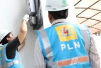 Ilustrasi petugas PLN sedang melakukan penambahan daya instalasi listrik pelanggan